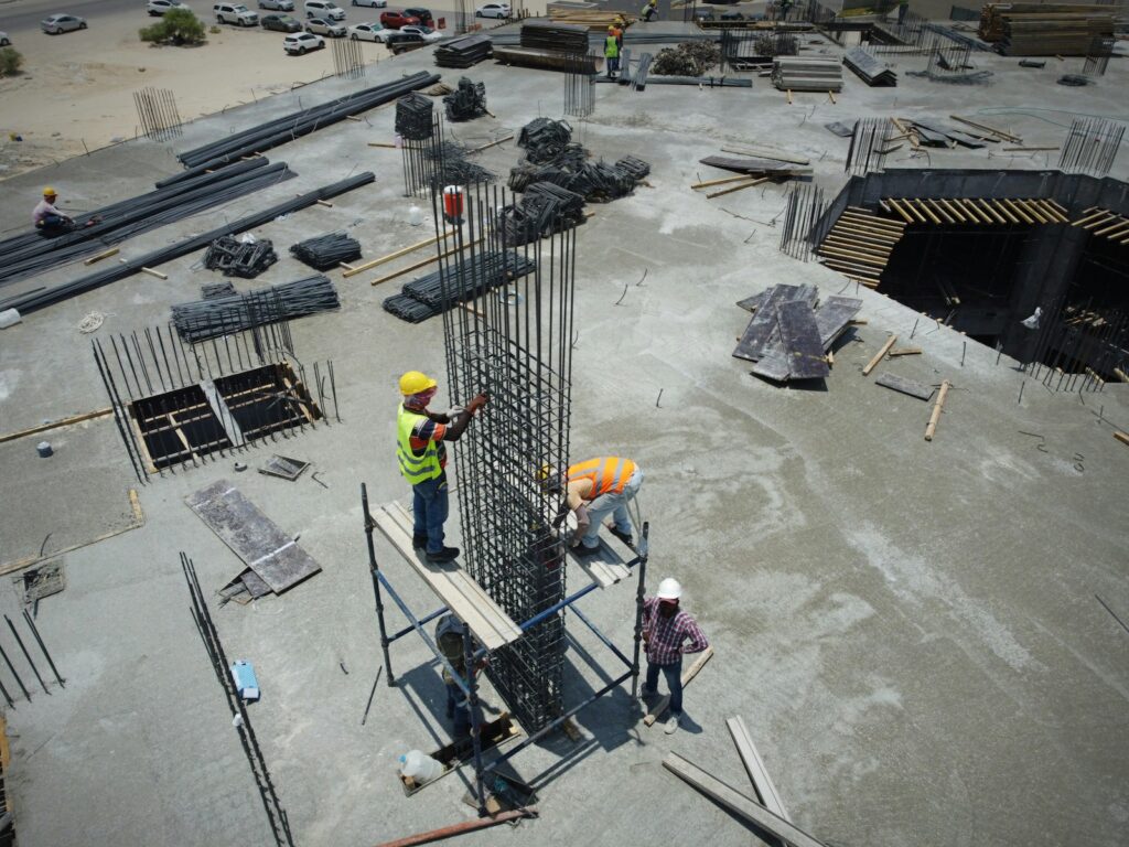 a group of men standing on top of a construction site